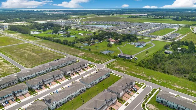an aerial view of a city with lawn chairs