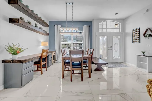 a kitchen with kitchen island granite countertop a stove top oven a sink a counter top space and cabinets