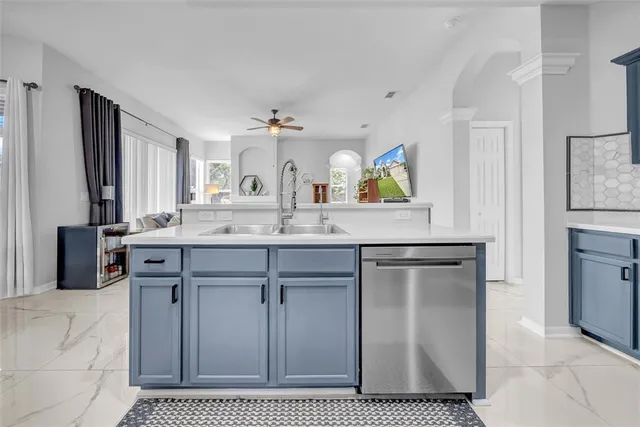 a living room with furniture a fireplace and a chandelier