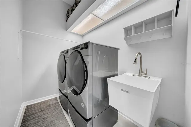 a view of a kitchen with refrigerator and furniture