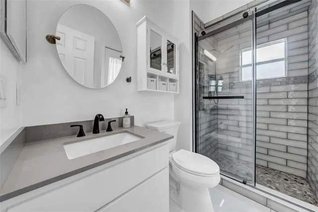 a living room filled with furniture and a potted plant
