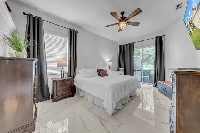 a view of a house with a yard and potted plants