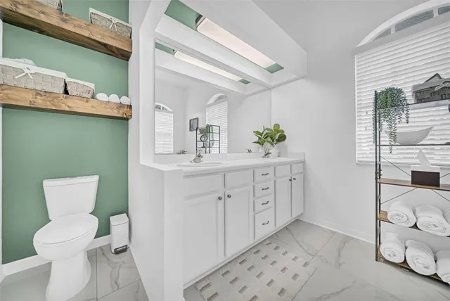 an aerial view of residential houses with outdoor space and trees