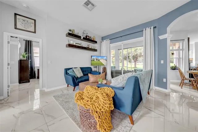 a view of a dining room with furniture and a chandelier
