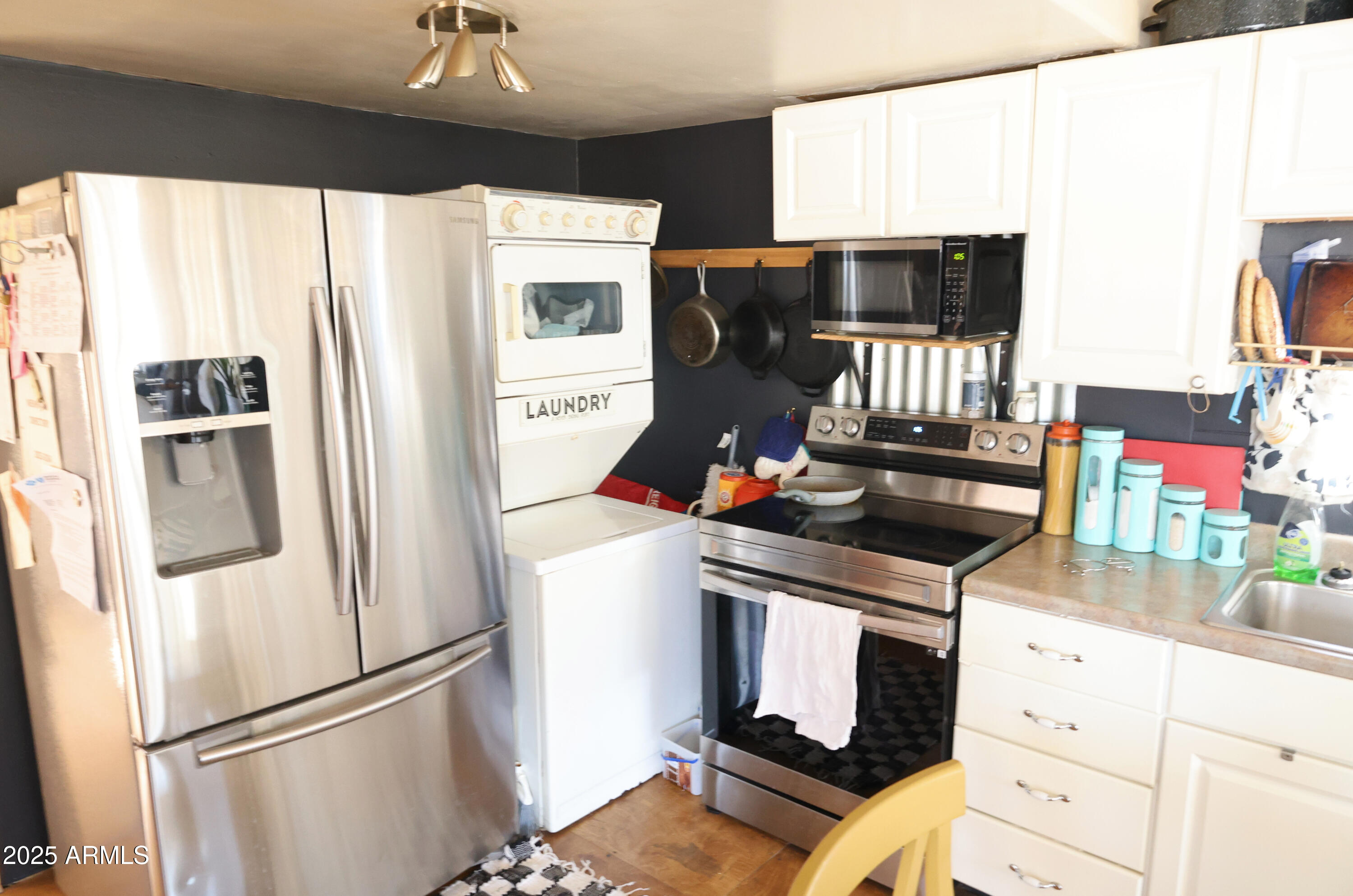 2015 South Wickiup Road, Unit 12 Apache Junction, AZ 85119 - Photo 6 of 12 a kitchen with stainless steel appliances a refrigerator stove and microwave