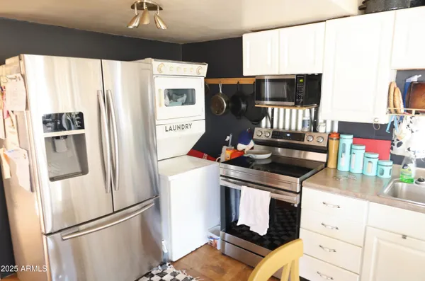 a kitchen with stainless steel appliances a refrigerator stove and microwave