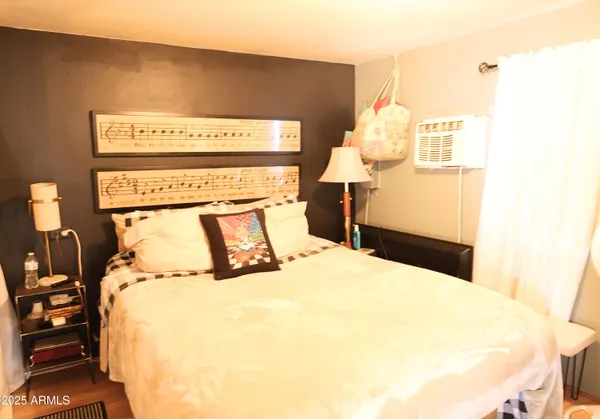 a bedroom with a bed and a night stand