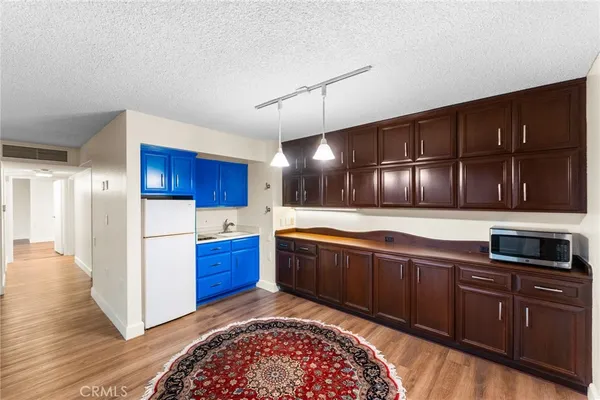 a large kitchen with wooden cabinets and stainless steel appliances