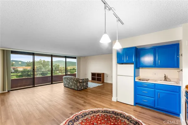 a kitchen with kitchen island a counter top space a sink and appliances