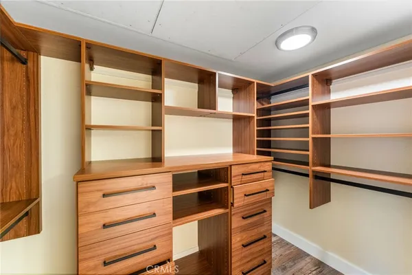 a view of walk in closet with empty racks
