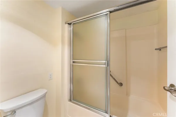 a bathroom with a glass shower door