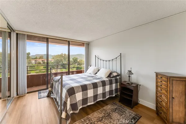 a bedroom with a bed next to a window