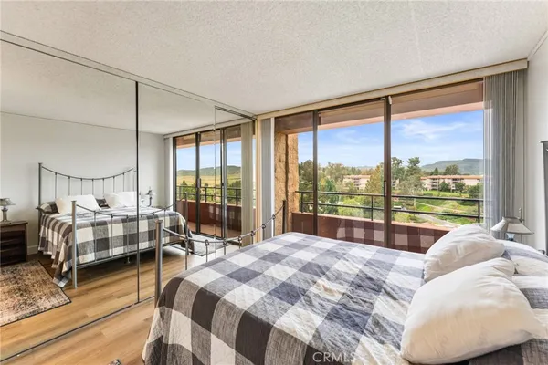 a bedroom with a bed and glass window