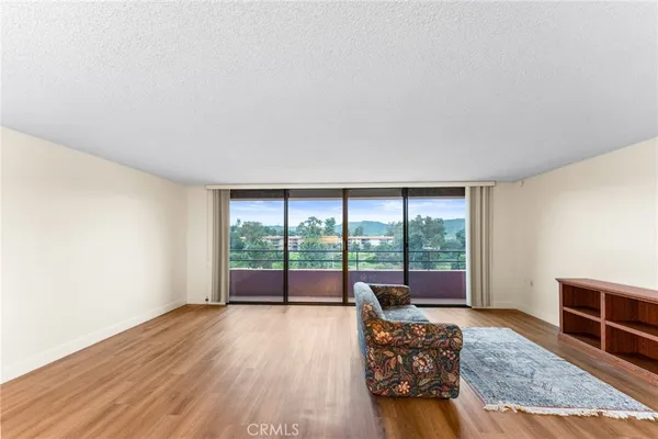 a living room with furniture and a floor to ceiling window