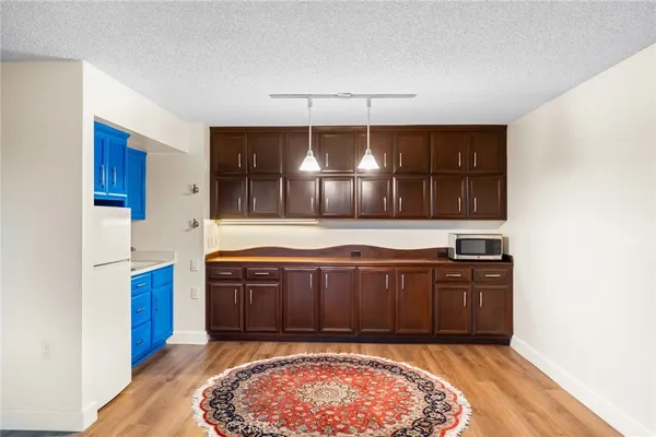 a view of kitchen with cabinets and wooden floor