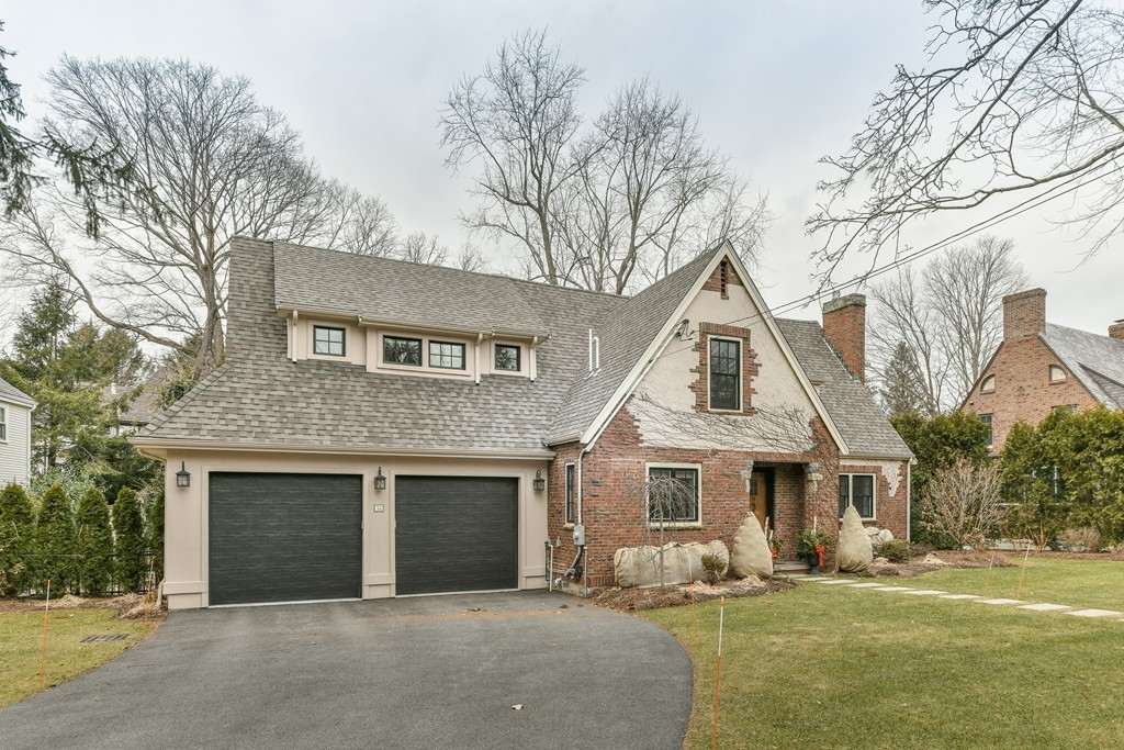 a front view of a house with a yard and garage