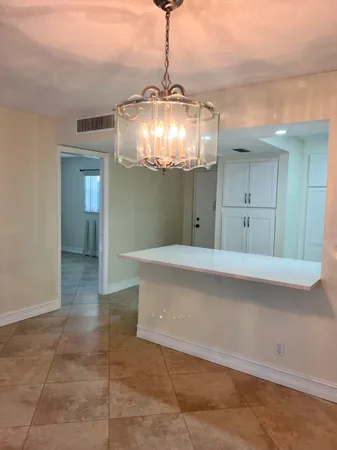 a view of a hallway view with chandelier