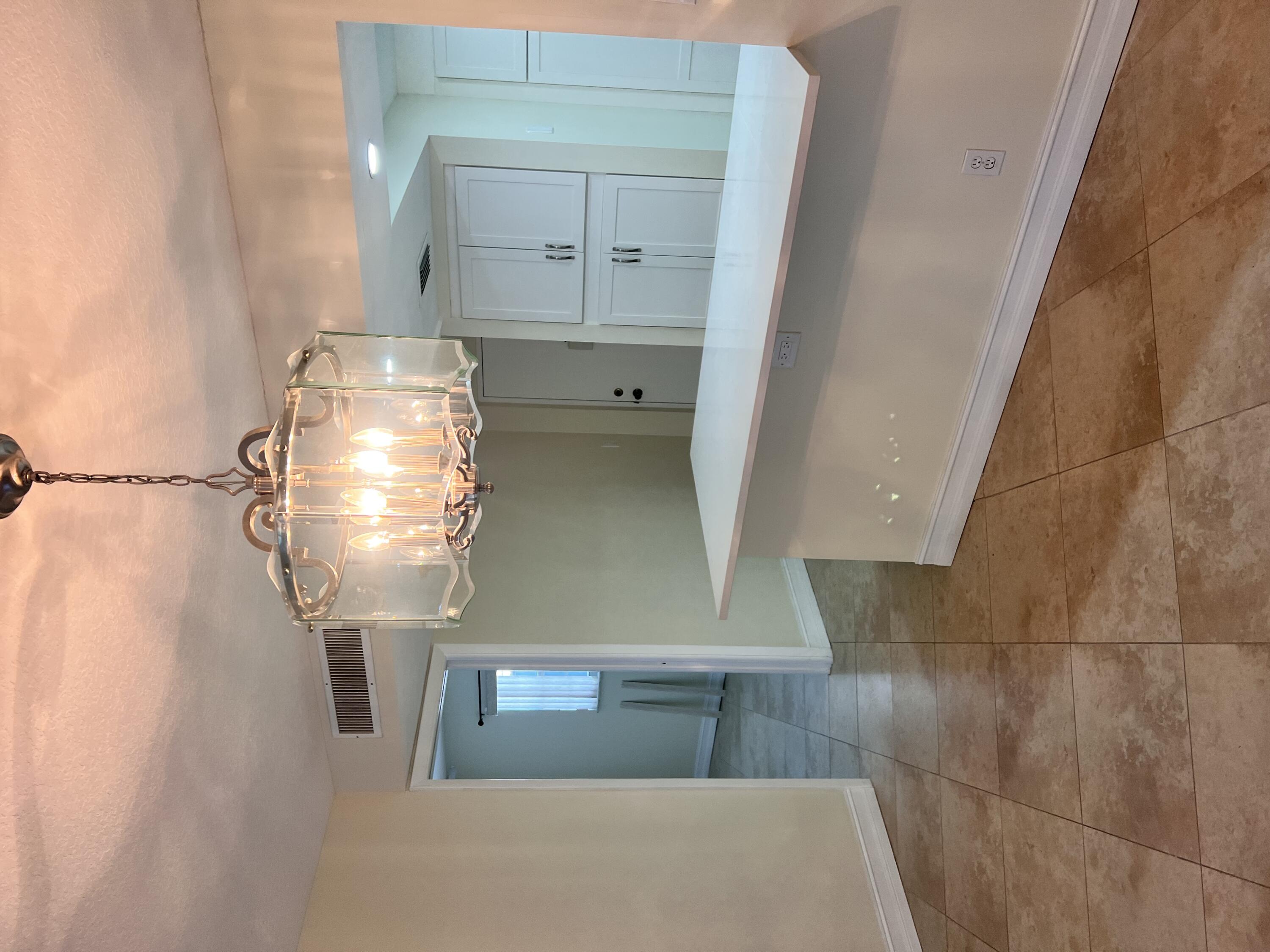 a view of a hallway view with chandelier