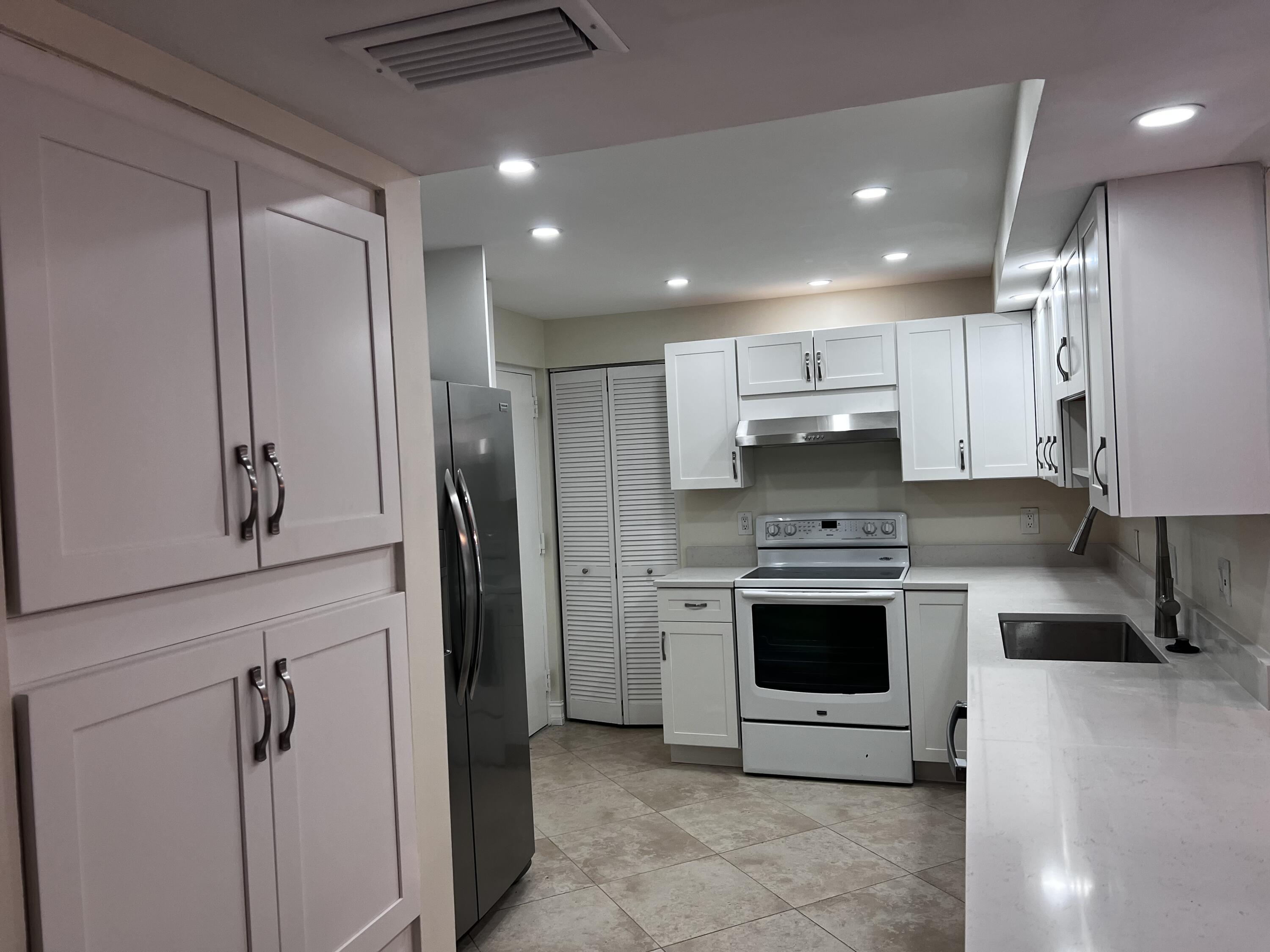 6000 Northwest 2nd Avenue, Unit 439 Boca Raton, FL 33487 - Photo 2 of 12 a kitchen with stainless steel appliances granite countertop a refrigerator and a sink