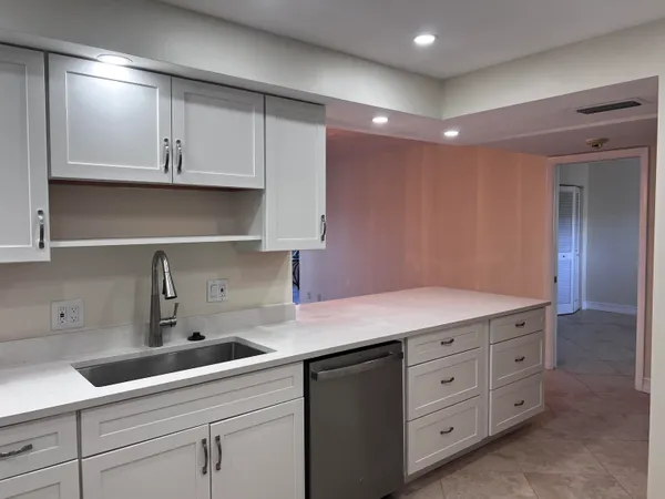 a kitchen with white cabinets