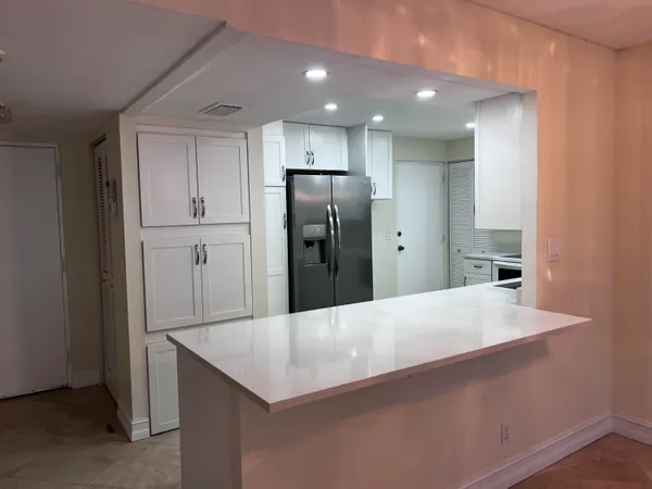 a kitchen with stainless steel appliances a refrigerator and microwave