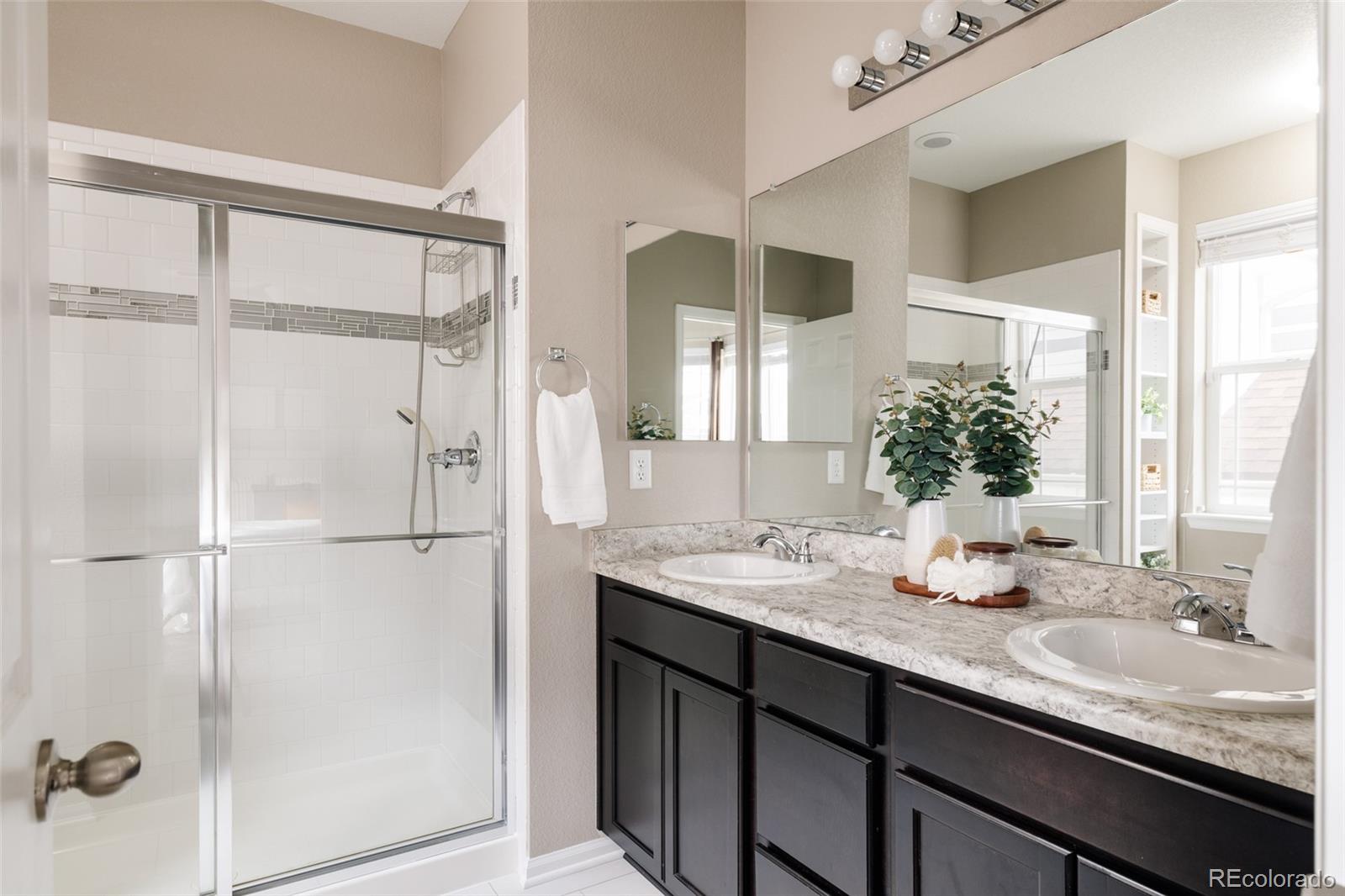 220 South Ider Way Aurora, CO 80018 - Photo 15 of 28 a bathroom with a granite countertop sink and a mirror