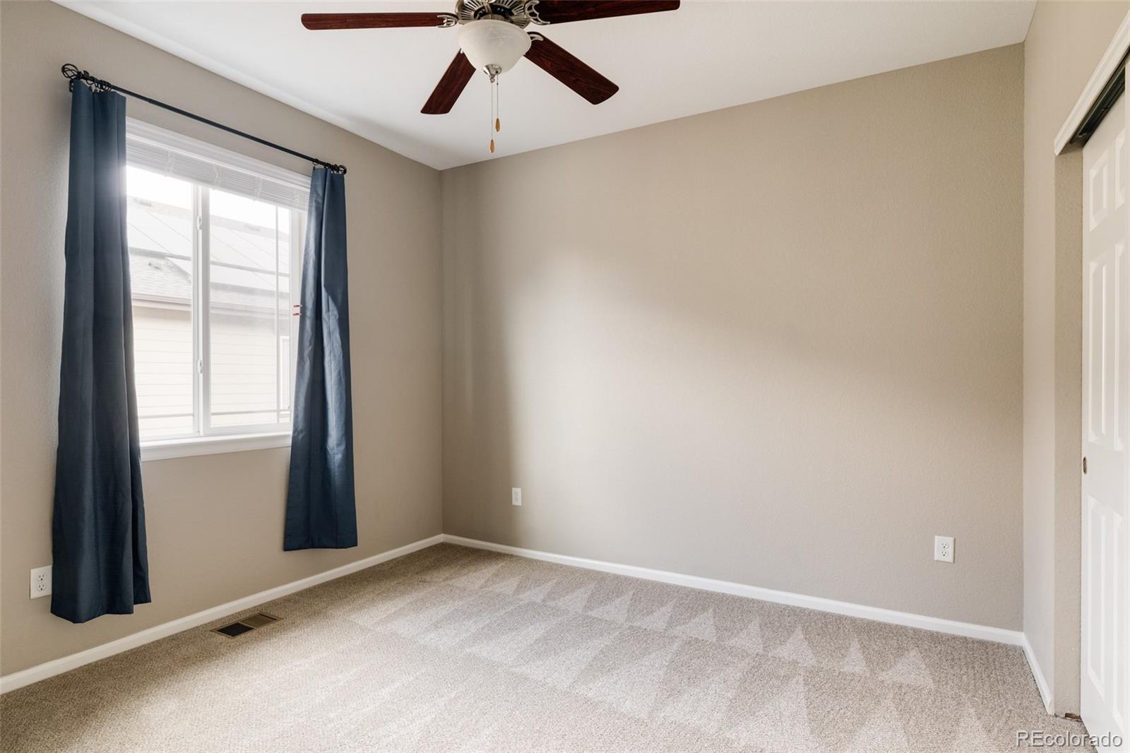 220 South Ider Way Aurora, CO 80018 - Photo 18 of 28 an empty room with a window and a ceiling fan