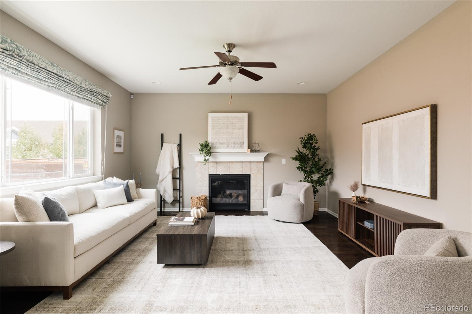 220 South Ider Way Aurora, CO 80018 - Photo 2 of 28 a living room with furniture a window and a fireplace