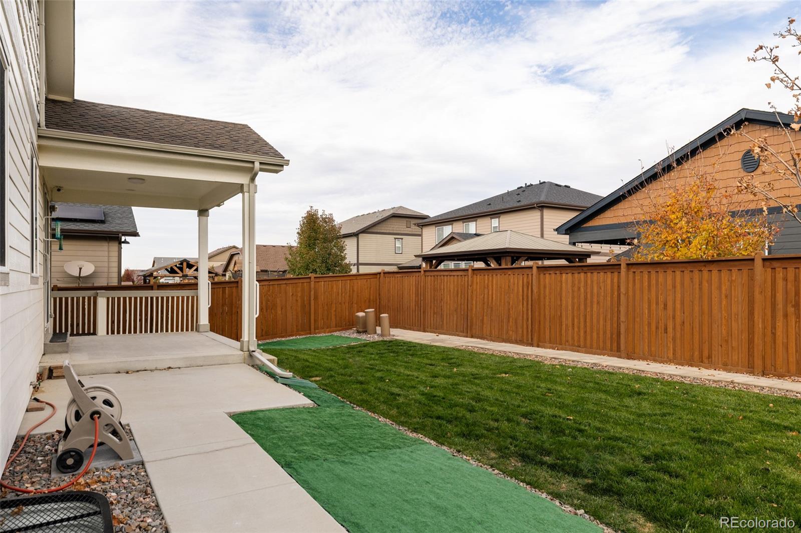 220 South Ider Way Aurora, CO 80018 - Photo 27 of 28 a view of a backyard with plants and a lake view