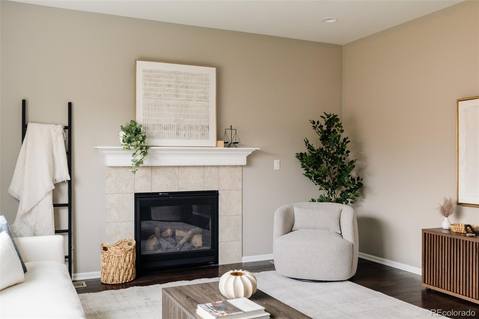 220 South Ider Way Aurora, CO 80018 - Photo 3 of 28 a living room with furniture and a fireplace