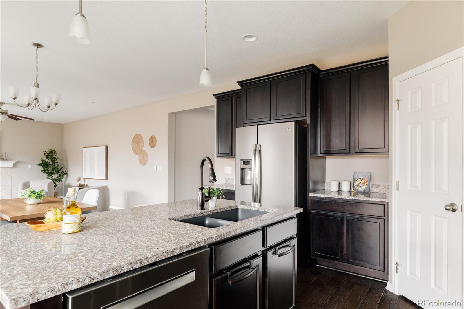 220 South Ider Way Aurora, CO 80018 - Photo 8 of 28 a kitchen with refrigerator and chairs