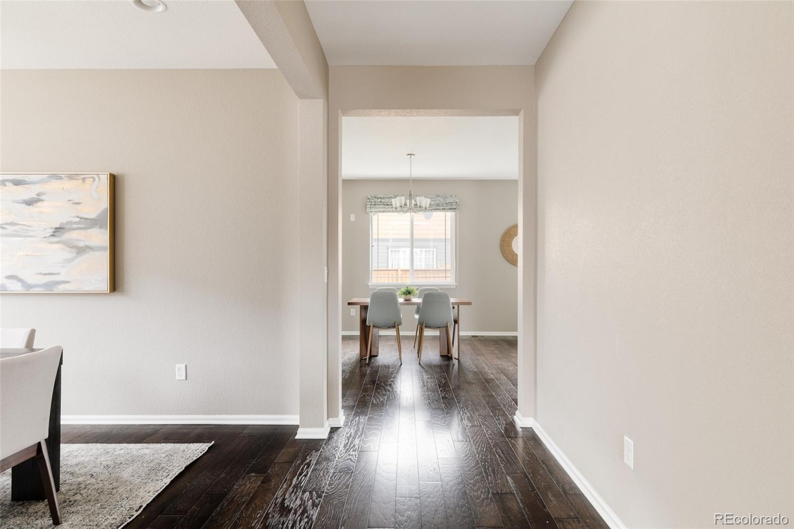 220 South Ider Way Aurora, CO 80018 - Photo 10 of 28 a view of a dining room with furniture window and wooden floor