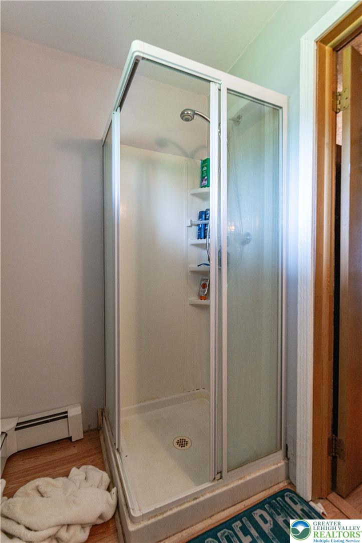 2485 Hieter Road Quakertown, PA 18951 - Photo 64 of 97 A glass-enclosed shower stall features convenient built-in shelving, optimizing space and utility.