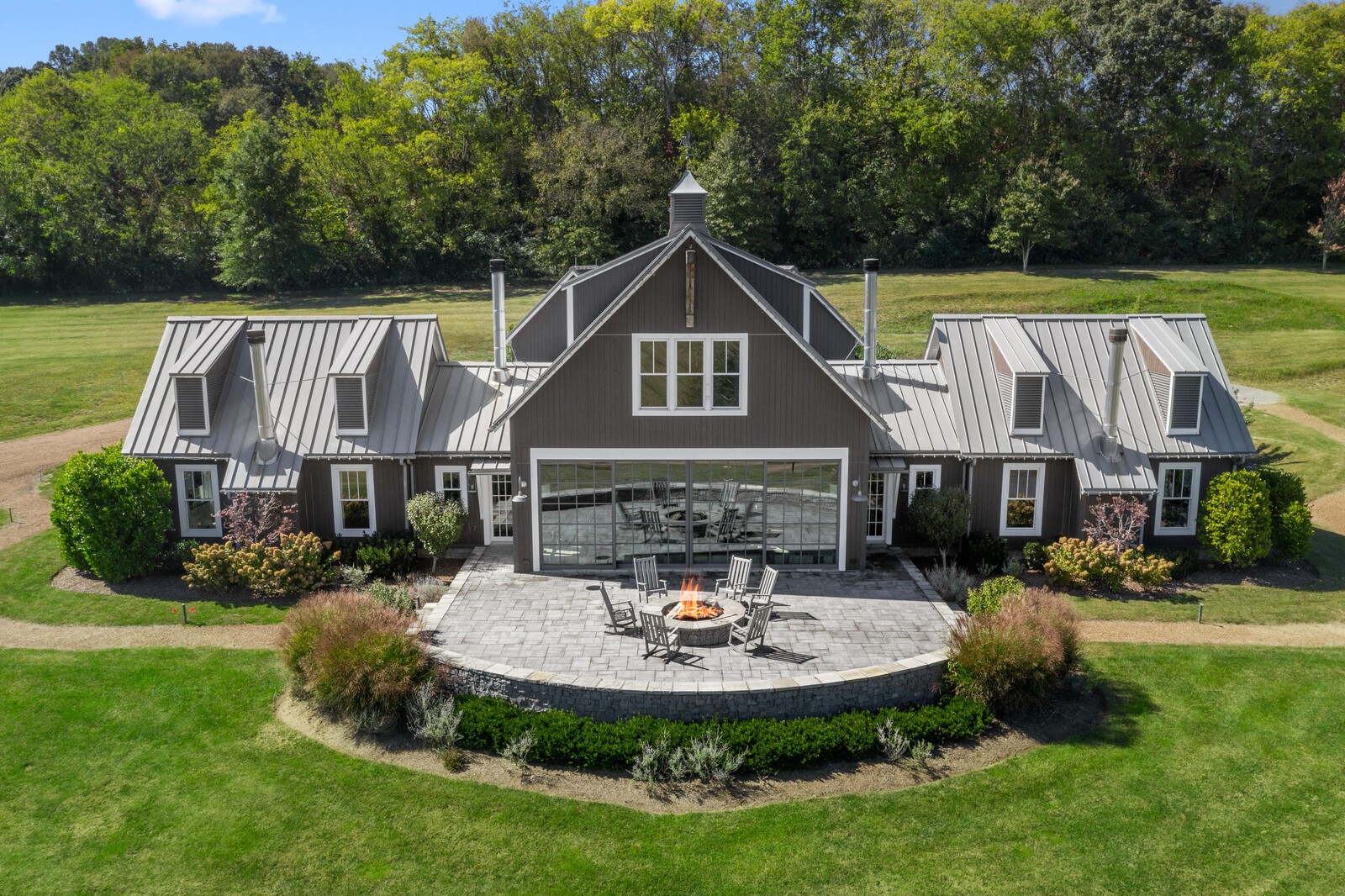 a aerial view of a house with swimming pool and a garden