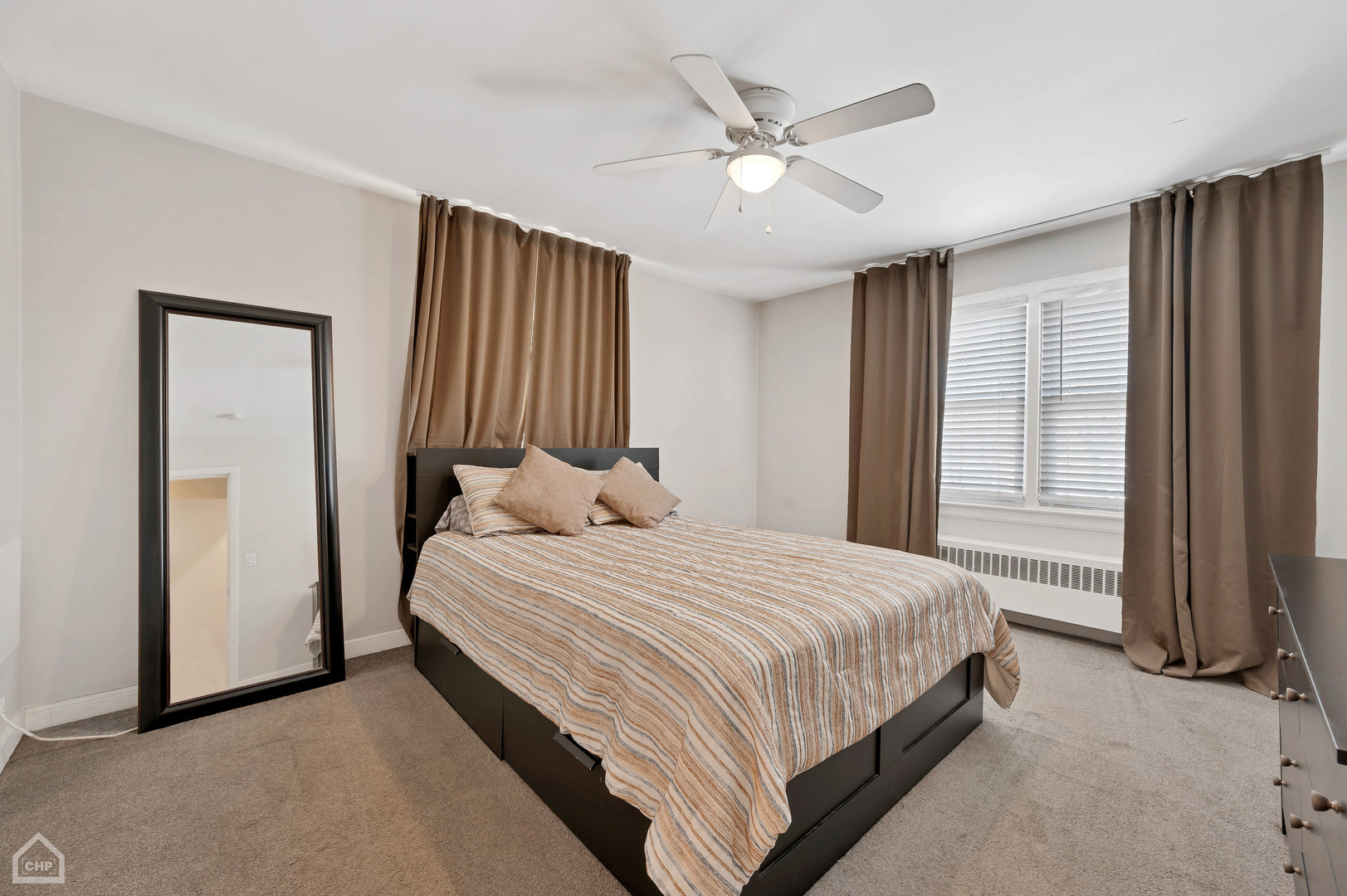 8912 Forestview Road, Unit 2 Evanston, IL 60203 - Photo 5 of 9 a bedroom with a large bed and a chandelier