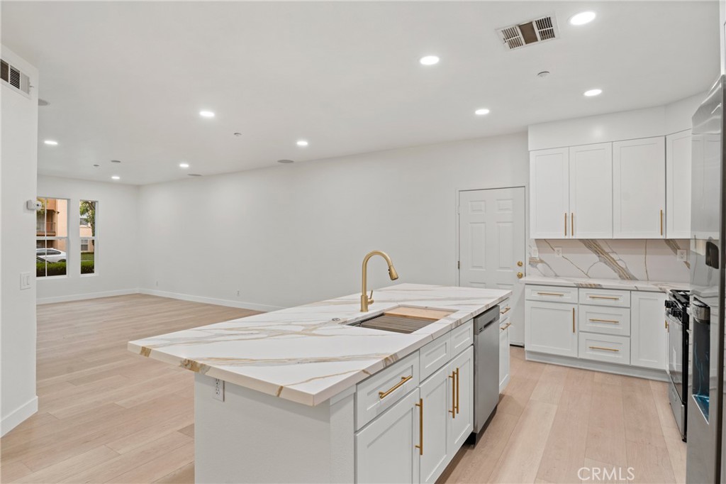 312 Quail Ridge Irvine, CA 92603 - Photo 12 of 21 a kitchen that has a sink a stove and a refrigerator