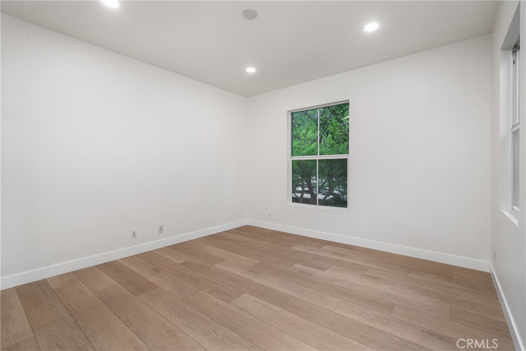 312 Quail Ridge Irvine, CA 92603 - Photo 15 of 21 an empty room with wooden floor and windows