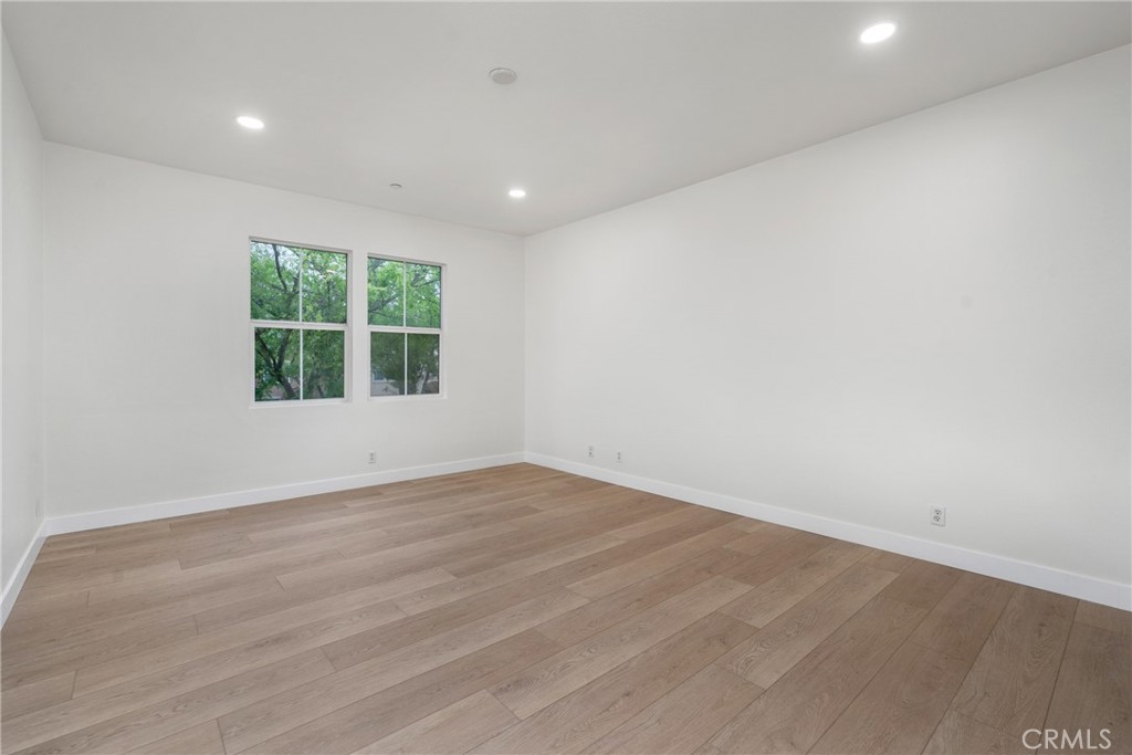 312 Quail Ridge Irvine, CA 92603 - Photo 17 of 21 an empty room with wooden floor and windows