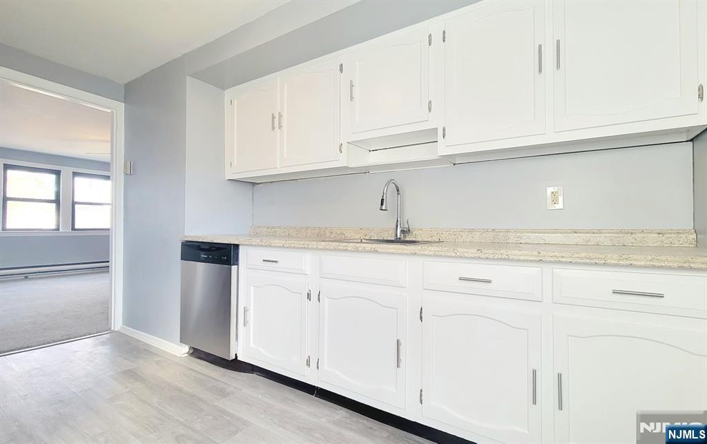 592 Beverly Road, Unit 2 Teaneck, NJ 07666 - Photo 3 of 7 a kitchen with white cabinets and sink
