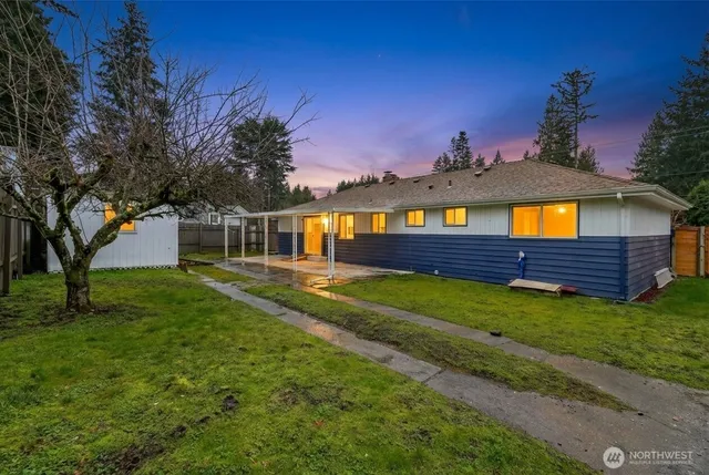 a view of backyard with barn and wooden fence