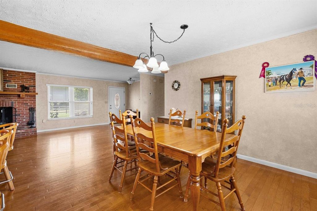 38730 Mickler Road Dade City, FL 33523 - Photo 12 of 38 a view of a dining room with furniture and wooden floor