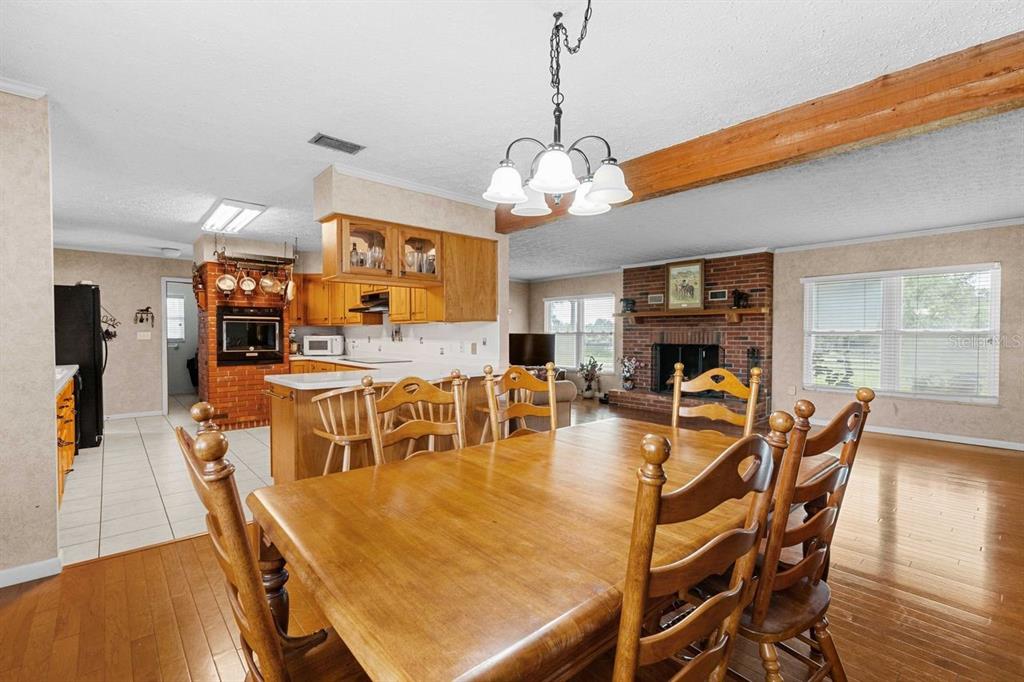 38730 Mickler Road Dade City, FL 33523 - Photo 13 of 38 a view of a dining room with furniture wooden floor and chandelier