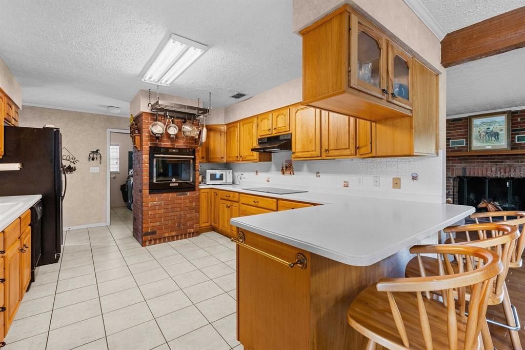 38730 Mickler Road Dade City, FL 33523 - Photo 14 of 38 a kitchen with stainless steel appliances granite countertop a sink and a refrigerator