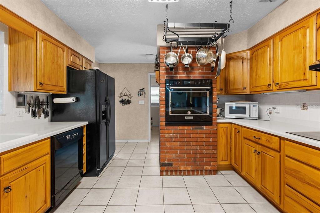 38730 Mickler Road Dade City, FL 33523 - Photo 16 of 38 a kitchen with stainless steel appliances granite countertop a refrigerator and a sink
