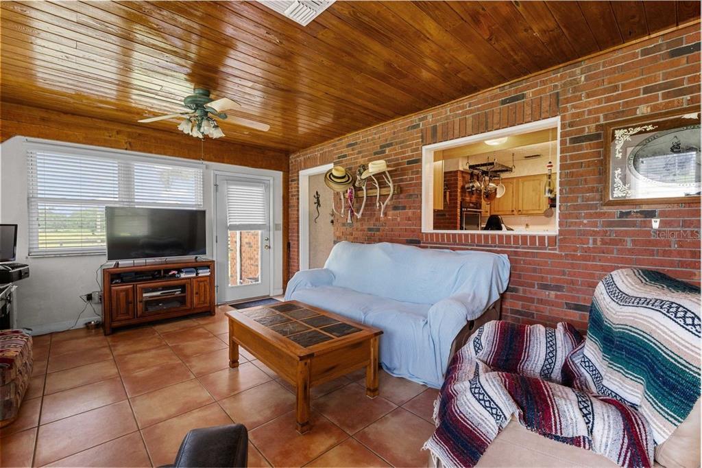 38730 Mickler Road Dade City, FL 33523 - Photo 19 of 38 a living room with furniture and a flat screen tv