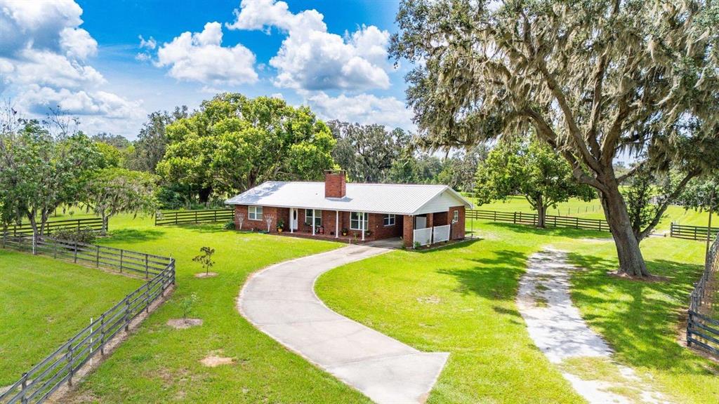 38730 Mickler Road Dade City, FL 33523 - Photo 26 of 38 a view of a house with swimming pool and sitting area