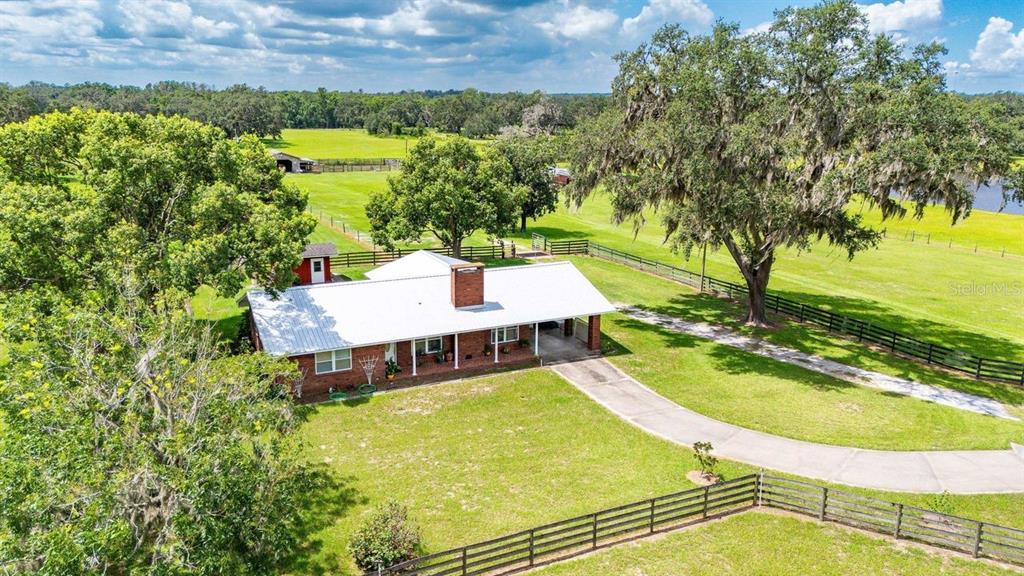 38730 Mickler Road Dade City, FL 33523 - Photo 27 of 38 a view of a swimming pool with a patio and a yard