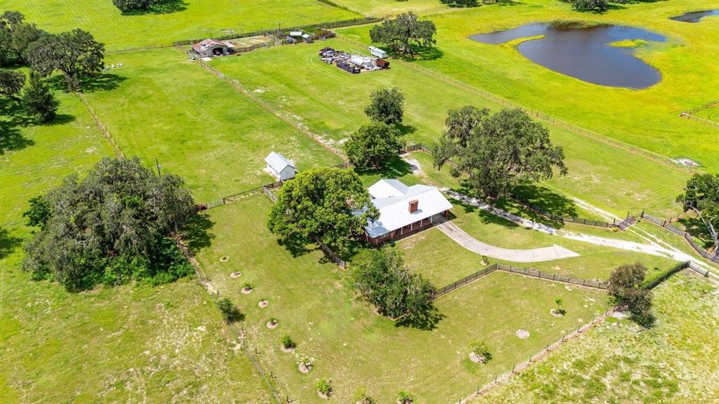 38730 Mickler Road Dade City, FL 33523 - Photo 32 of 38 a view of a swimming pool with a yard