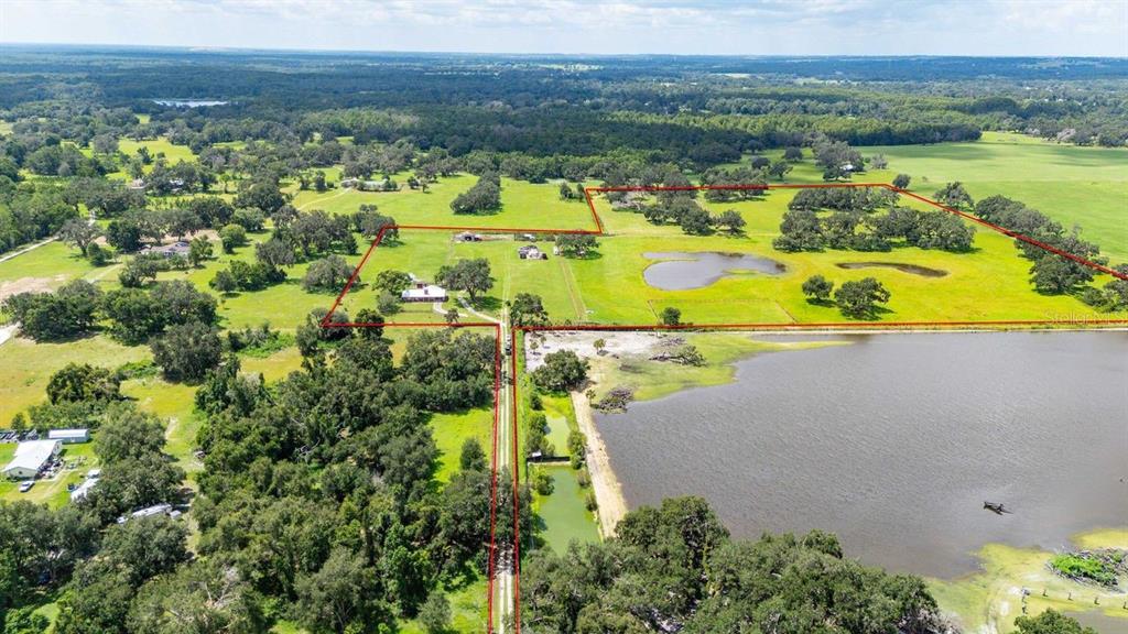 38730 Mickler Road Dade City, FL 33523 - Photo 36 of 38 an aerial view of residential houses with outdoor space and swimming pool