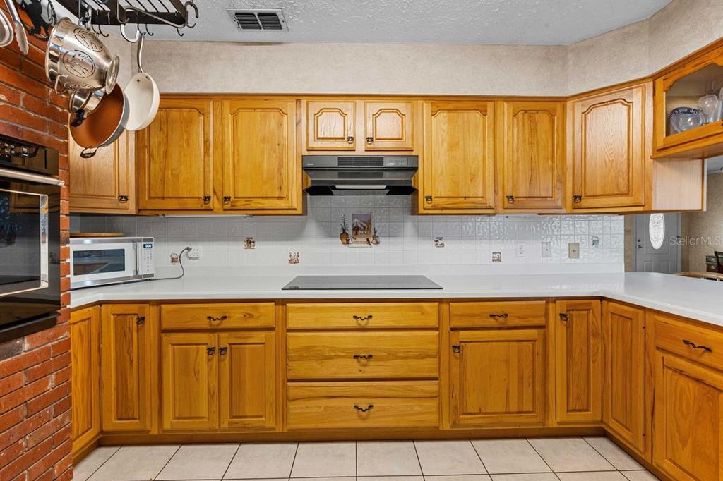38730 Mickler Road Dade City, FL 33523 - Photo 9 of 38 a kitchen with stainless steel appliances granite countertop a sink and cabinets